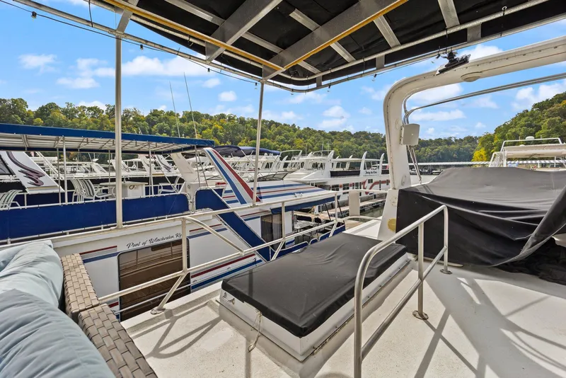 Slide: The Image of 2003 Monticello 18 X 70 River Yacht docked at marina, surrounded by lush greenery. - 22