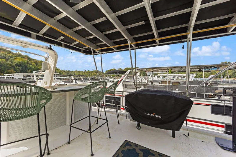Slide: The Image of Outdoor deck of 2003 Monticello 18 X 70 River Yacht with seating and grill. - 23