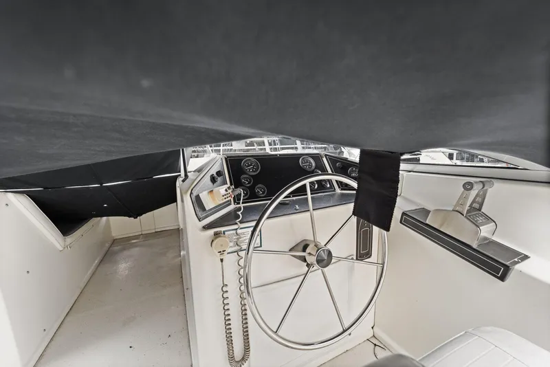 Slide: The Image of 2003 Monticello 18 X 70 River Yacht helm with steering wheel and controls. - 25