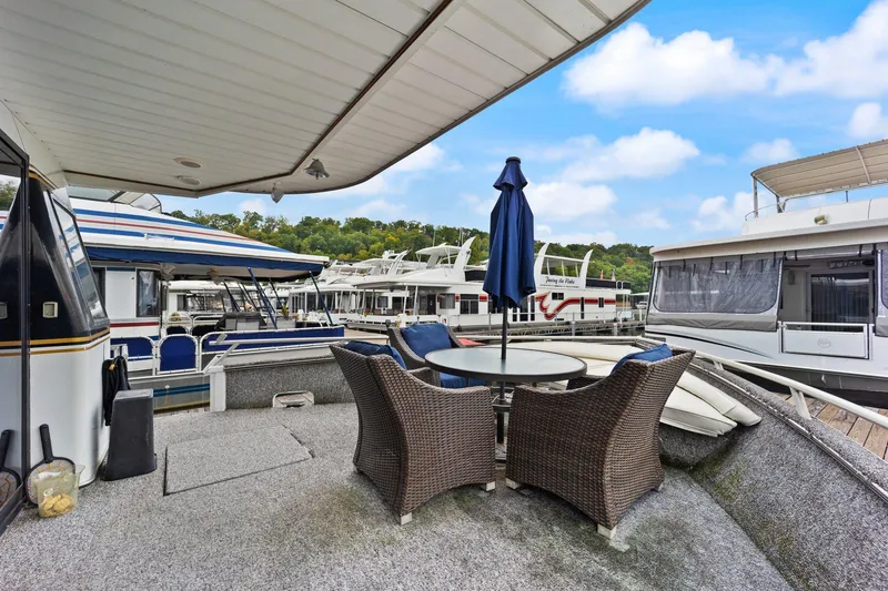 Slide: The Image of 2003 Monticello 18 X 70 River Yacht deck with wicker chairs and umbrella. - 27