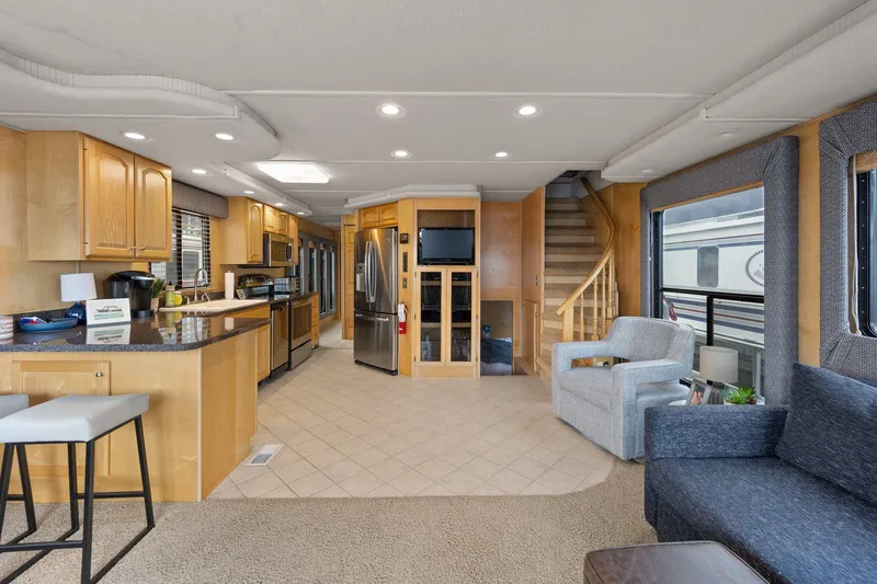 Slide: The Image of Luxurious interior of 2003 Monticello 18 X 70 River Yacht with modern kitchen and seating area. - 31