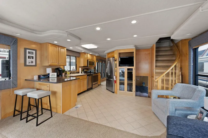 Slide: The Image of Luxurious interior of 2003 Monticello 18 X 70 River Yacht with modern kitchen and seating area. - 32