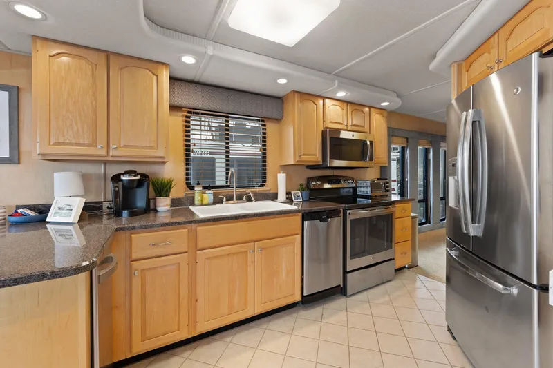 Slide: The Image of Modern kitchen interior in 2003 Monticello 18 X 70 River Yacht with stainless steel appliances. - 35