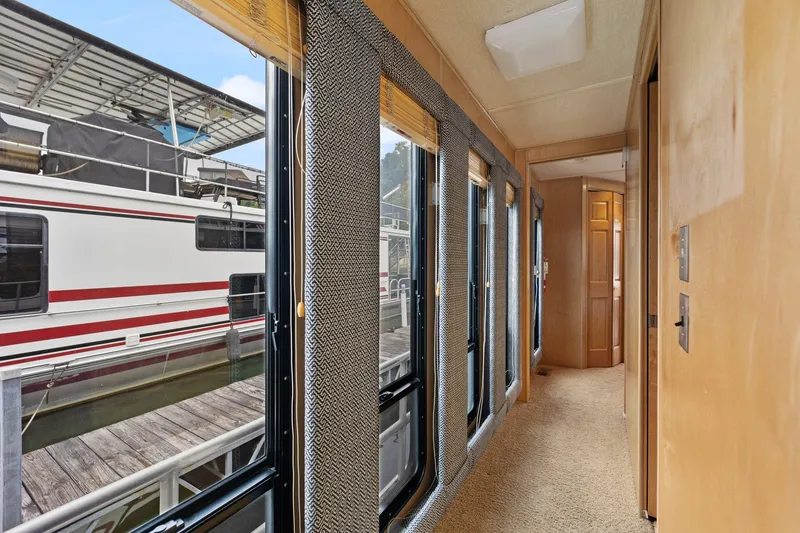 Slide: The Image of Interior hallway of 2003 Monticello 18 X 70 River Yacht with large windows. - 40