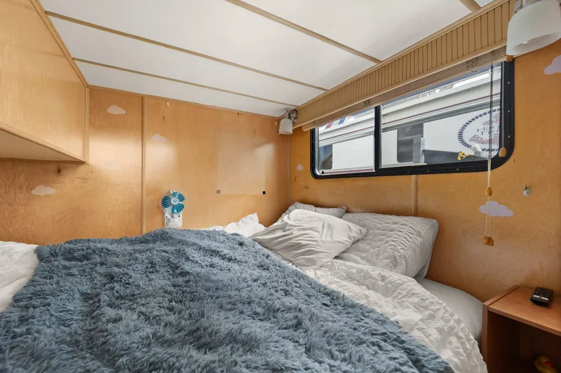 Slide: The Image of Cozy bedroom in 2003 Monticello 18 X 70 River Yacht with plush bedding. - 47