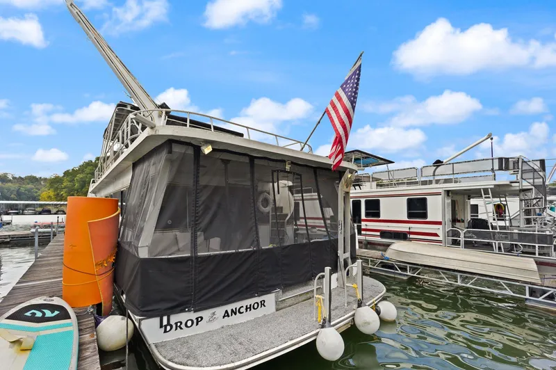 Slide: The Image of 2003 Monticello 18 X 70 River Yacht docked with American flag. - 8