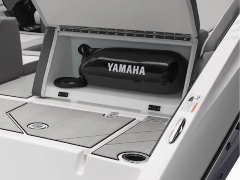 Slide: The Image of 2025 Yamaha Boats 252XE storage compartment with Yamaha-branded equipment inside. - 12