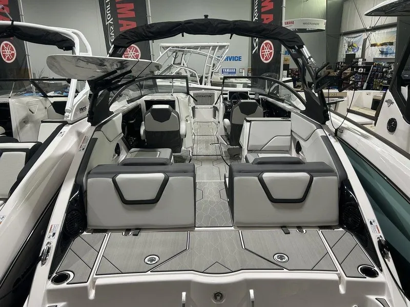 Slide: The Image of 2025 Yamaha Boats 252XE interior with sleek seating and modern design in showroom. - 3