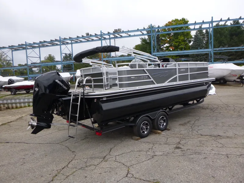 Slide: The Image of 2024 Ranger Reata 223C pontoon boat on trailer, parked outdoors. - 1