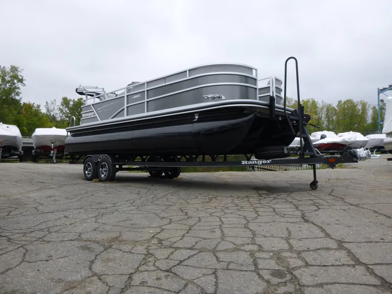 Slide: The Image of 2024 Ranger Reata 223C boat on trailer in outdoor lot. - 13