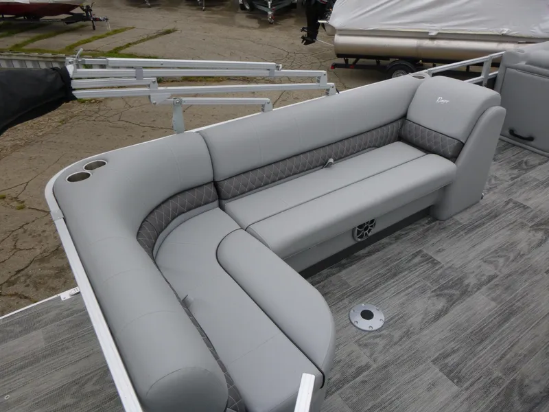 Slide: The Image of 2024 Ranger Reata 223C boat with gray seating and wood-style flooring. - 21