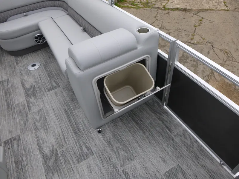 Slide: The Image of 2024 Ranger Reata 223C boat interior with gray seating and built-in storage compartment. - 24