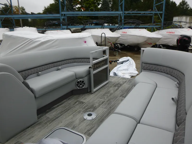 Slide: The Image of 2024 Ranger Reata 223C pontoon boat interior with gray seating and wood-style flooring. - 27
