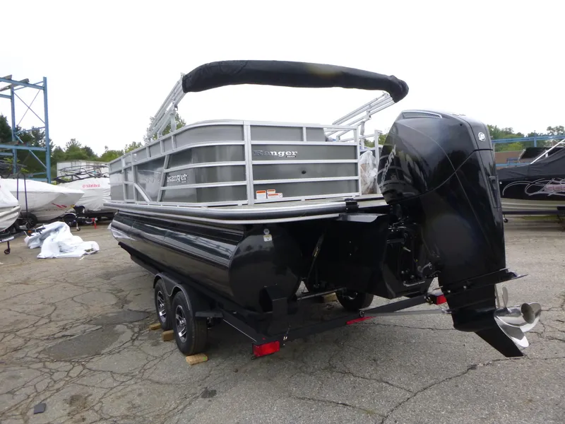 Slide: The Image of 2024 Ranger Reata 223C pontoon boat with black motor on a trailer. - 3