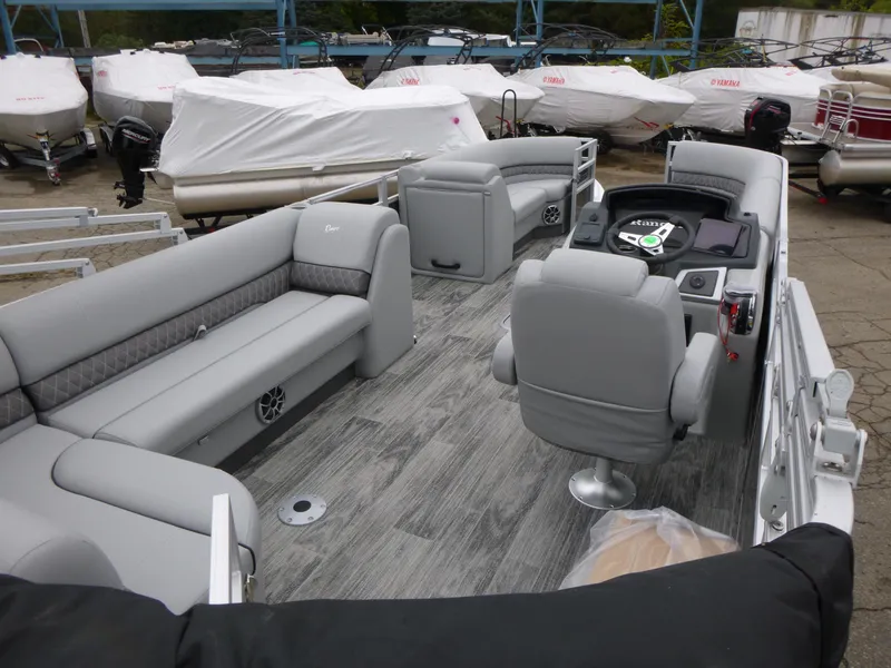 Slide: The Image of 2024 Ranger Reata 223C pontoon boat with spacious seating and modern interior design. - 30