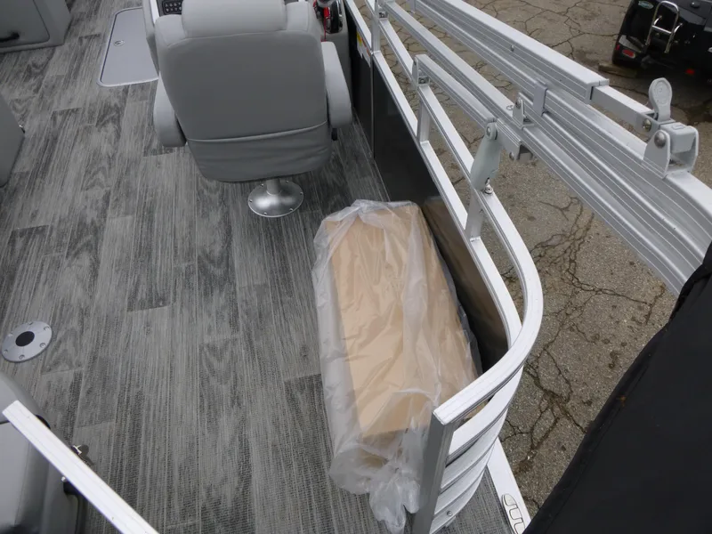 Slide: The Image of 2024 Ranger Reata 223C boat interior with gray seating and wood-textured flooring. - 31