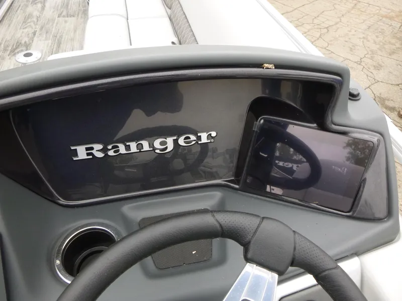 Slide: The Image of 2024 Ranger Reata 223C dashboard with steering wheel and display screen. - 32