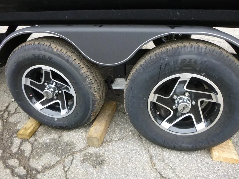 Slide: The Image of 2024 Ranger Reata 223C trailer wheels on wooden blocks. - 33