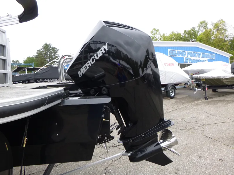 Slide: The Image of 2024 Ranger Reata 223C with Mercury outboard motor in a marina setting. - 35