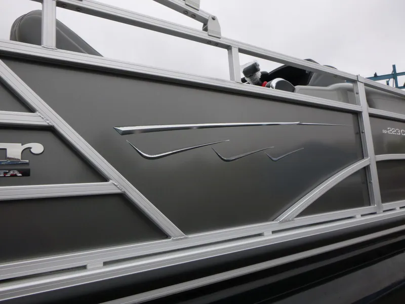 Slide: The Image of 2024 Ranger Reata 223C pontoon boat with sleek metallic design and railing details. - 39