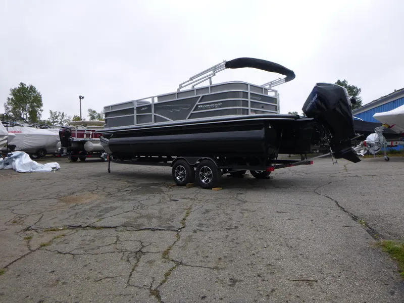 Slide: The Image of 2024 Ranger Reata 223C pontoon boat on trailer in parking lot. - 4