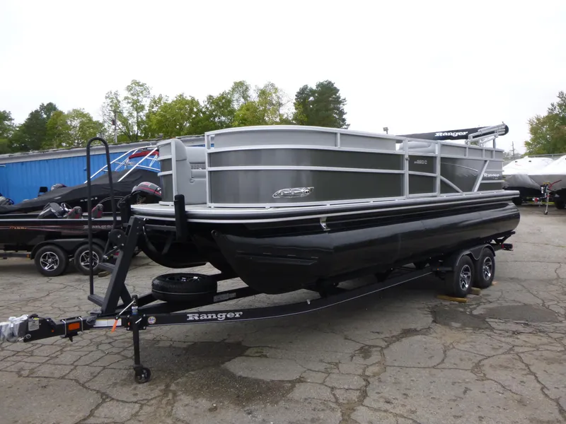 Slide: The Image of 2024 Ranger Reata 223C pontoon boat on trailer in outdoor setting. - 7
