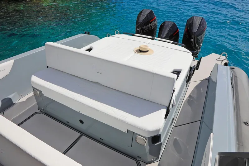 Slide: The Image of Ranieri CAYMAN 45.0 Cruiser 2025, rear view with seating and triple engines on blue water. - 14