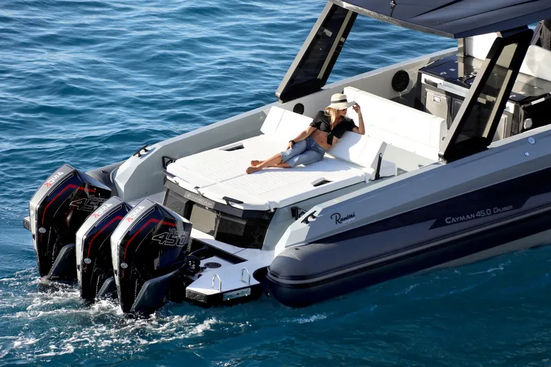 Slide: The Image of 2025 Ranieri CAYMAN 45.0 Cruiser on water, person relaxing on deck. - 5