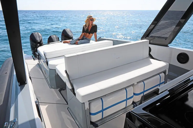 Slide: The Image of 2025 Ranieri CAYMAN 45.0 Cruiser on ocean, woman relaxing on deck. - 12