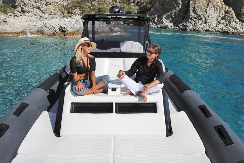 Slide: The Image of Couple relaxing on 2025 Ranieri CAYMAN 45.0 Cruiser in clear blue waters. - 13