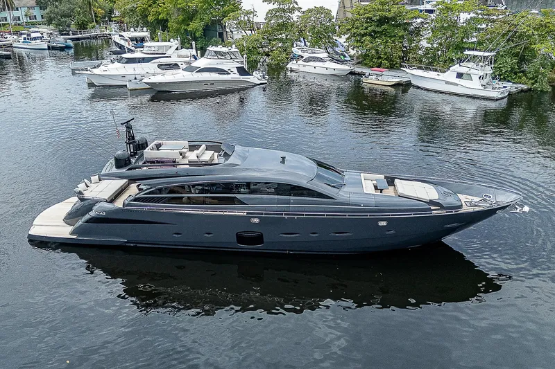 Slide: The Image of 2014 Pershing 92 yacht on a serene waterway, surrounded by other boats. - 0