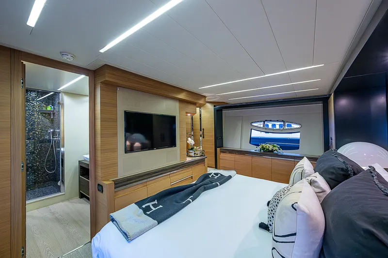 Slide: The Image of Luxurious bedroom interior of 2014 Pershing 92 yacht with modern decor and large window. - 11