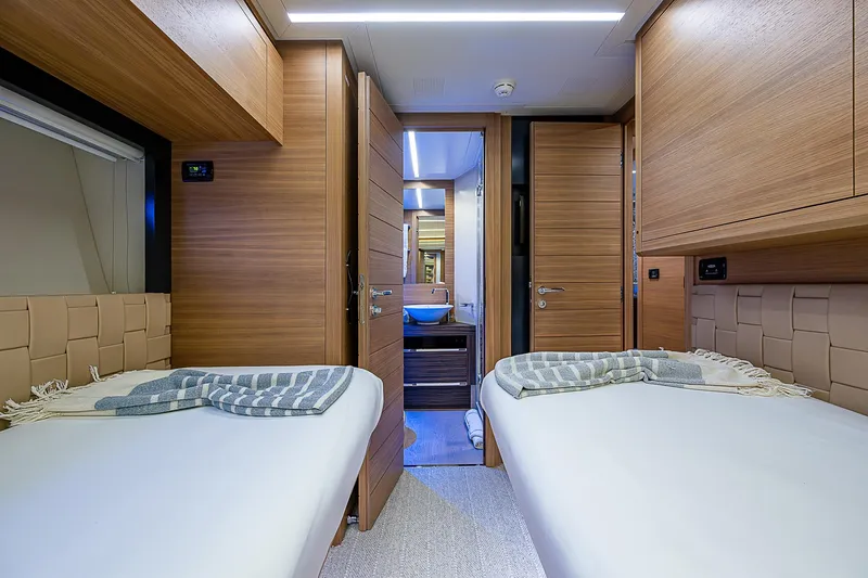 Slide: The Image of Luxurious twin cabin interior of 2014 Pershing 92 yacht with modern wood finishes. - 21