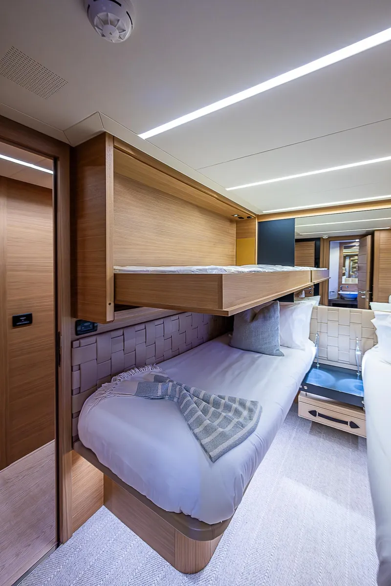Slide: The Image of Luxurious interior of 2014 Pershing 92 yacht with modern bunk beds. - 22
