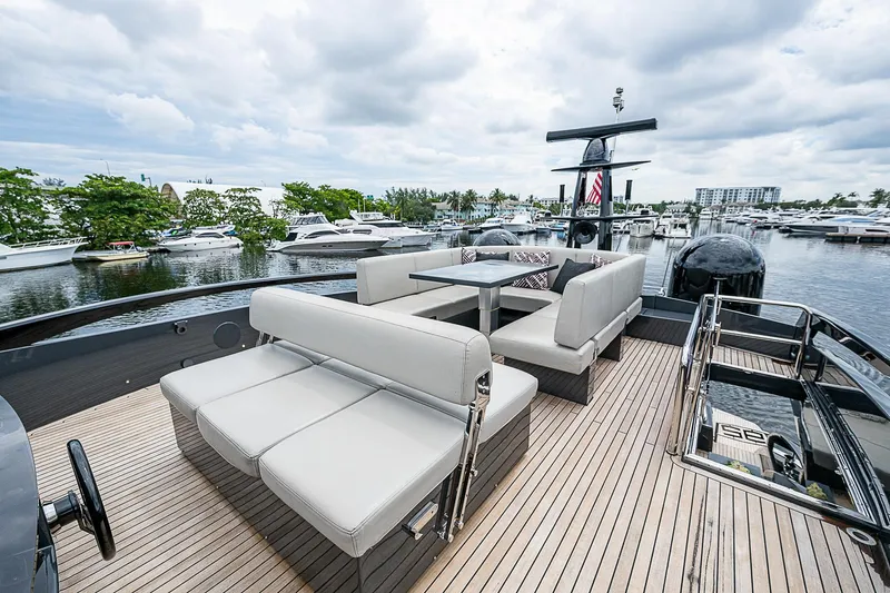 Slide: The Image of Luxurious 2014 Pershing 92 yacht deck with elegant seating and scenic marina view. - 29