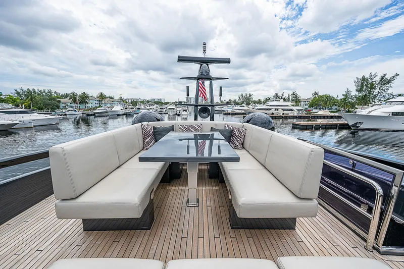 Slide: The Image of Luxurious 2014 Pershing 92 yacht with elegant outdoor seating and scenic marina view. - 31