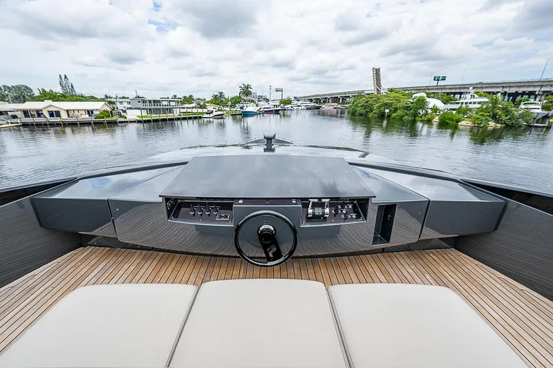 Slide: The Image of 2014 Pershing 92 yacht helm with waterfront view, featuring sleek design and modern controls. - 34