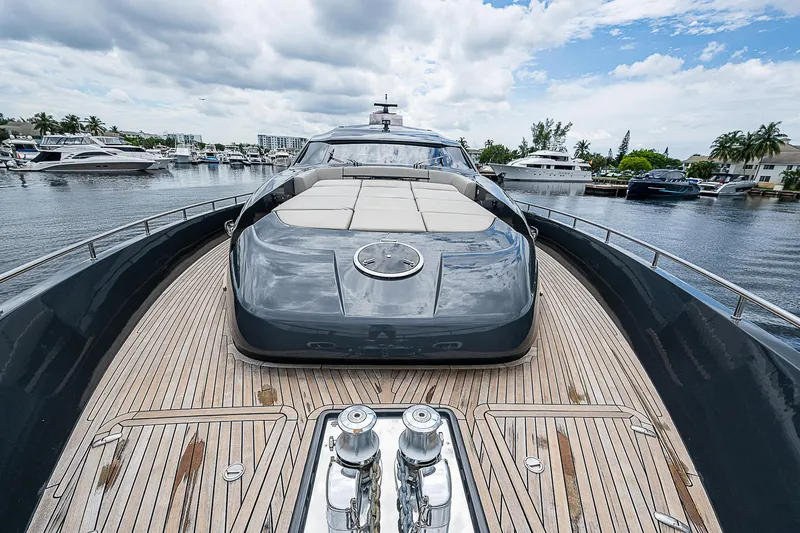 Slide: The Image of Luxury Pershing 92 yacht, 2014 model, docked in a marina under a cloudy sky. - 36