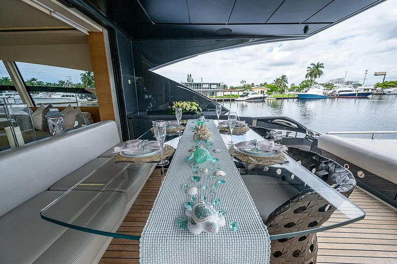 Slide: The Image of Luxurious dining setup on 2014 Pershing 92 yacht, overlooking serene waterfront. - 39