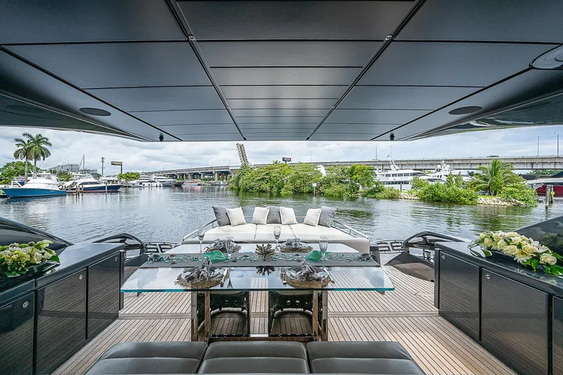 Slide: The Image of Luxurious 2014 Pershing 92 yacht deck with elegant dining area and scenic marina view. - 41