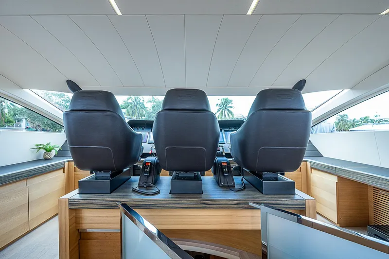 Slide: The Image of Interior helm of 2014 Pershing 92 yacht with three black captain chairs. - 6