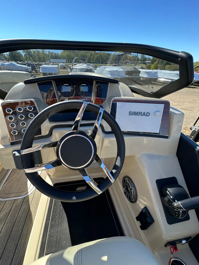 Slide: The Image of 2024 Starcraft RX23QDC 3.0 boat dashboard with steering wheel and Simrad display. - 10