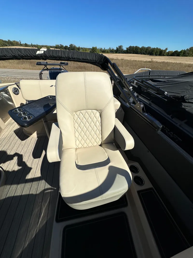 Slide: The Image of 2024 Starcraft RX23QDC 3.0 boat interior with luxurious captain's chair and sleek design. - 12