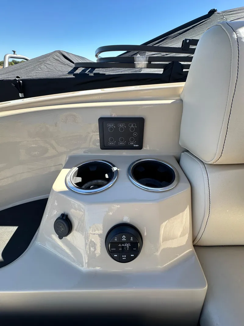 Slide: The Image of 2024 Starcraft RX23QDC 3.0 boat interior with cup holders and control panel. - 16