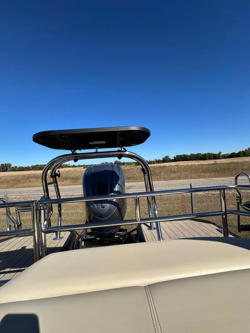 Slide: The Image of 2024 Starcraft RX23QDC 3.0 boat with sleek design and powerful engine, set against a clear blue sky. - 20