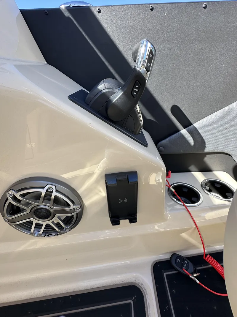 Slide: The Image of 2024 Starcraft RX23QDC 3.0 boat interior with control panel, speaker, and cup holders. - 23