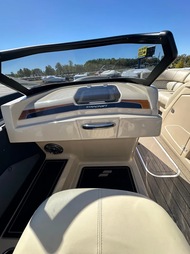 Slide: The Image of 2024 Starcraft RX23QDC 3.0 boat dashboard with modern controls and seating. - 24