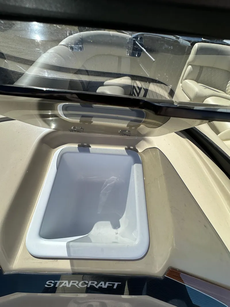 Slide: The Image of 2024 Starcraft RX23QDC 3.0 boat interior with built-in cooler compartment. - 25