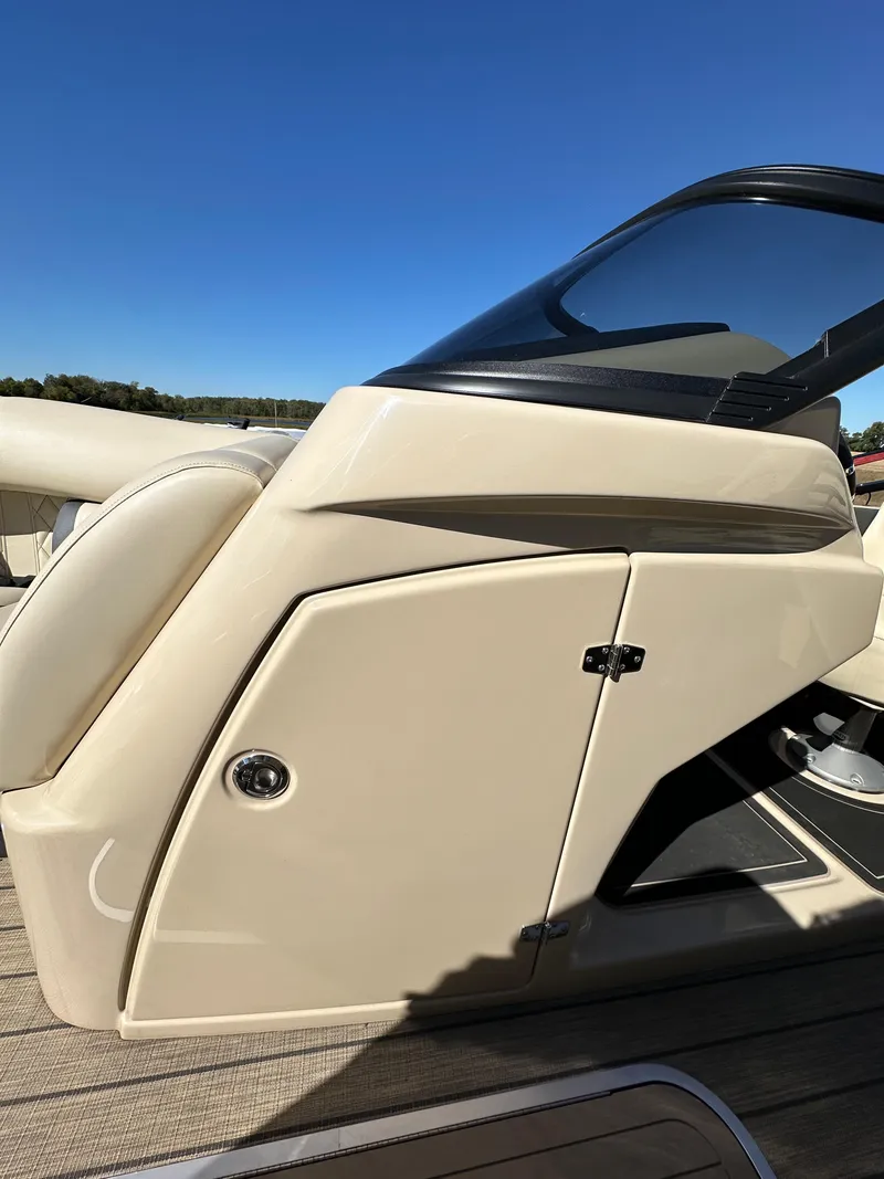 Slide: The Image of 2024 Starcraft RX23QDC 3.0 boat, sleek design, beige exterior, clear blue sky background. - 27