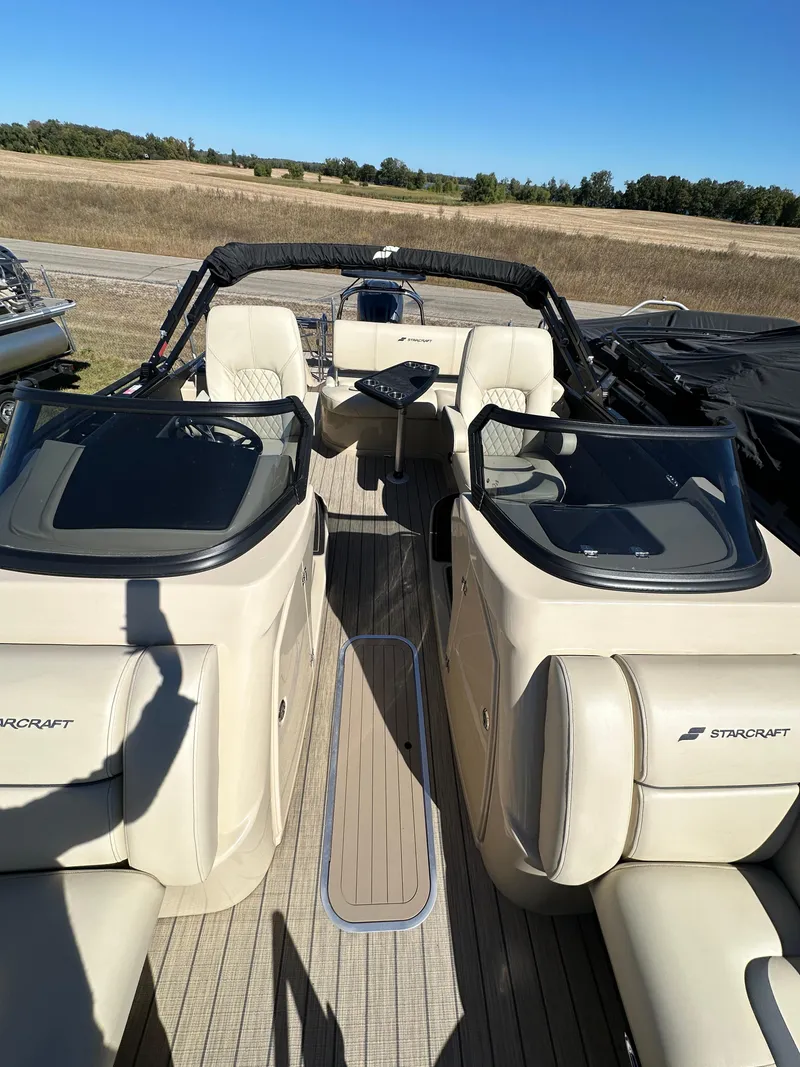 Slide: The Image of 2024 Starcraft RX23QDC 3.0 boat interior with beige seating and sleek design. - 6